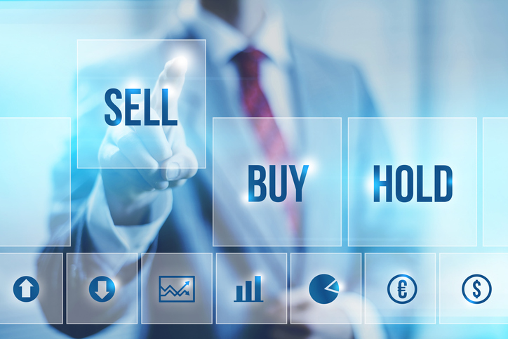 Vector image of businessman standing in front of holographic image displaying text button options that read "sell" "buy" and "hold"