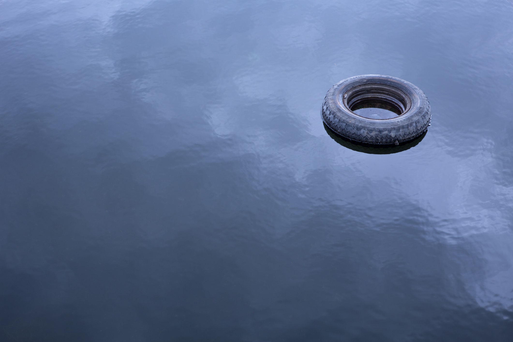 Old tire floating in water