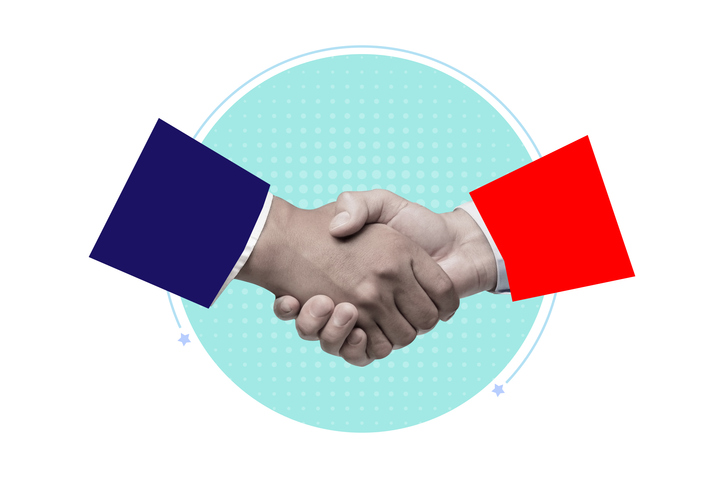 Collage of two businesspeople's arms, one with a blue suit and one with a red suit, shaking hands against a light blue spotlight