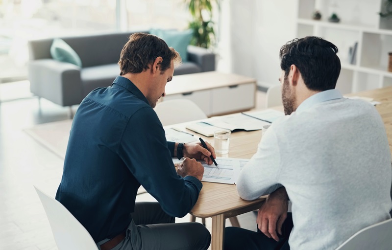 Teamwork, finance and investment with a man meeting his broker while talking about portfolio growth. Collaboration, accounting or wealth management with a male employee and trading advisor at work