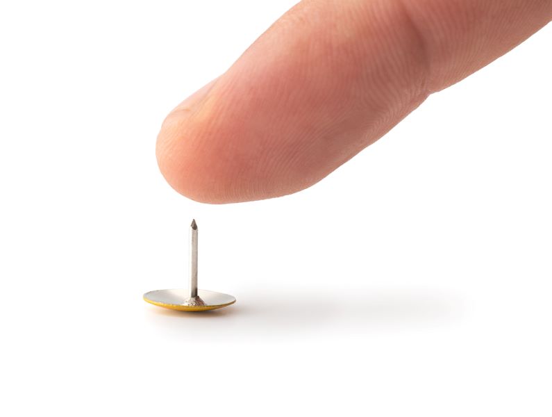 Finger hovering over thumb tack to indicate a pain point.