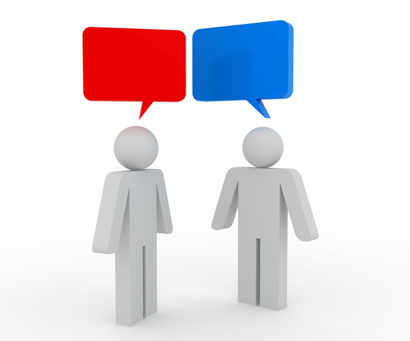 Two figures with balloons over their heads, representing communication