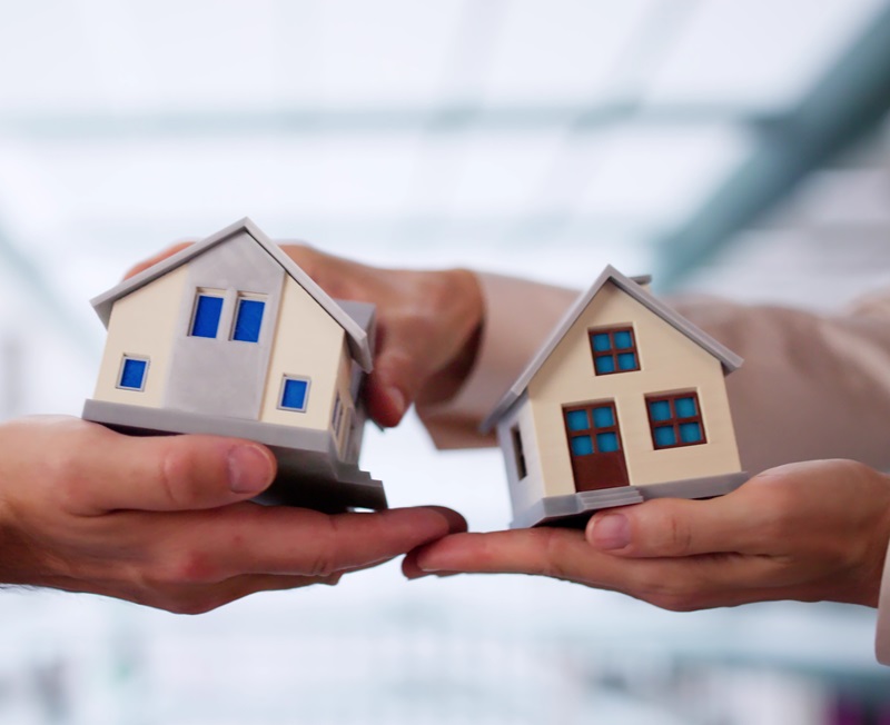 Hand House Swap And Property Insurance Concept