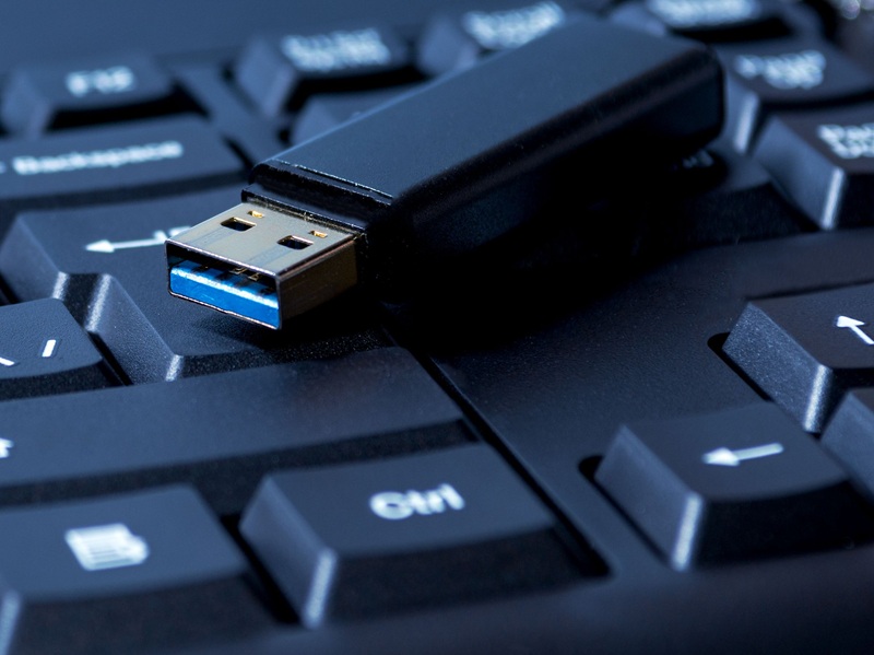 USB memory stick resting on computer keyboard