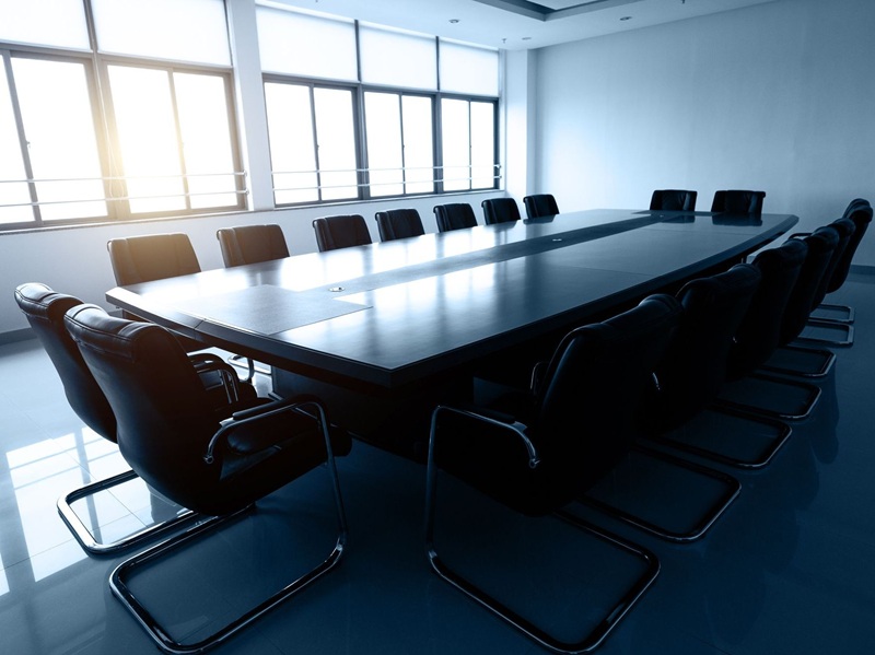 Conference table and chairs in empty meeting room