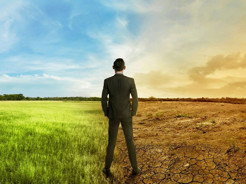 Businessman standing between different climates