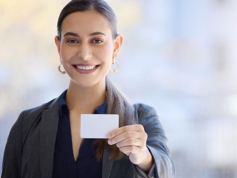 Broker handing someone her business card