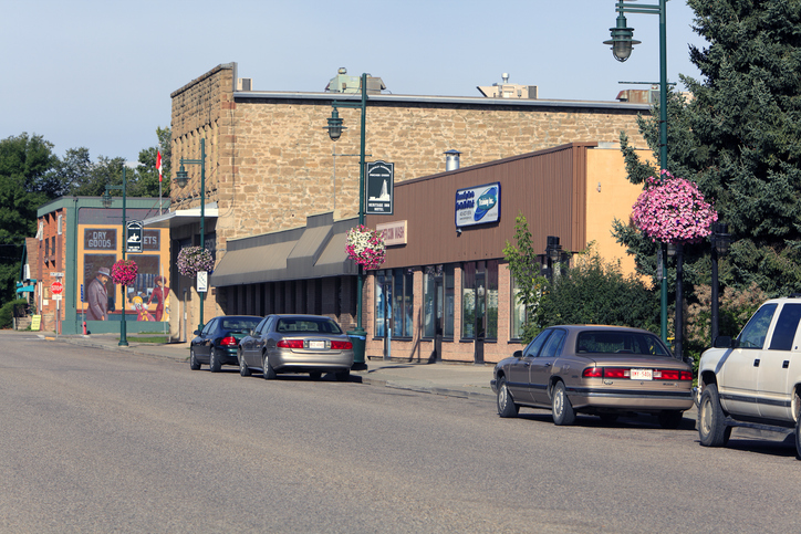 Main Street lined on the right side with buildings and cars in Pincher Creek Alberta