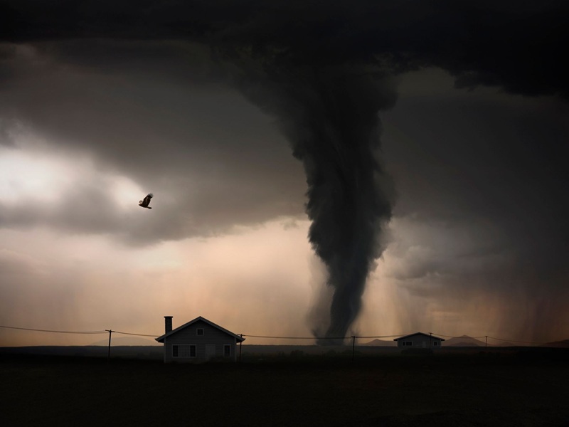 A tornado moving towards a rural home
