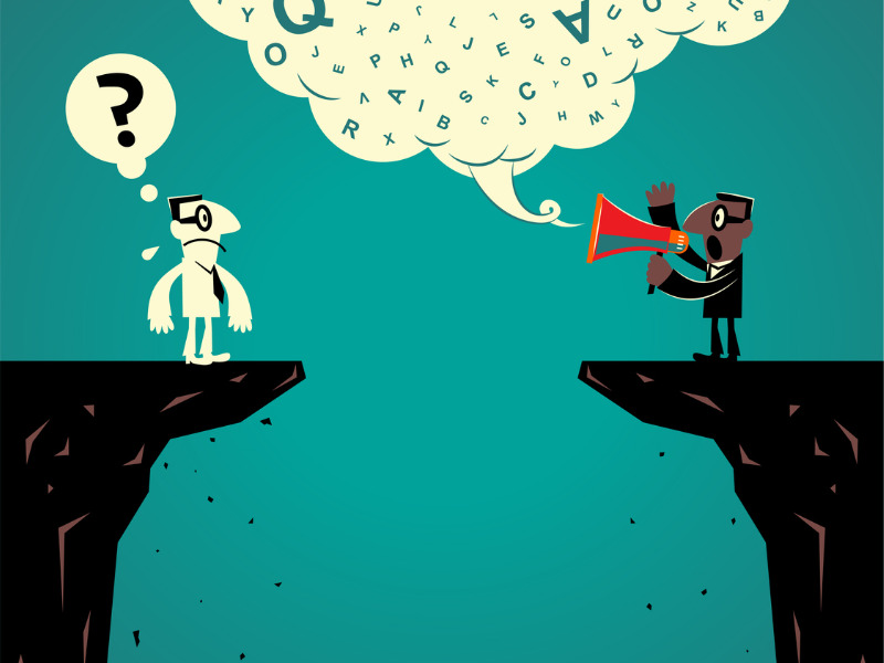 Two businessmen standing at the edge of a cliff having communication problems.