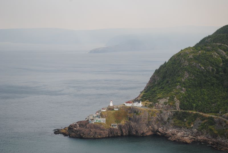 Wildfire smoke is seen blanketing Newfoundland's coast, south of the lighthouse at Fort Amherst, in St. John's, N.L., on Monday, Aug. 11, 2025. THE CANADIAN PRESS/Sarah Smellie