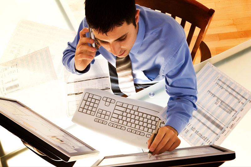 Businessman on mobile phone and computer.
