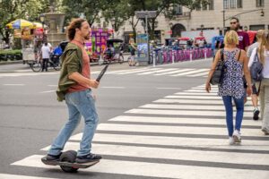 Why an electric skateboarder was given a retrial on a charge of riding without insurance Image
