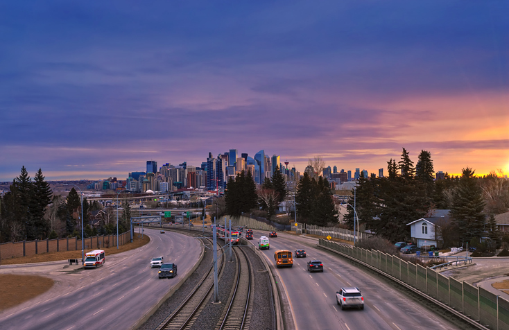 A panoramic sunrise over city roads in Calgary.