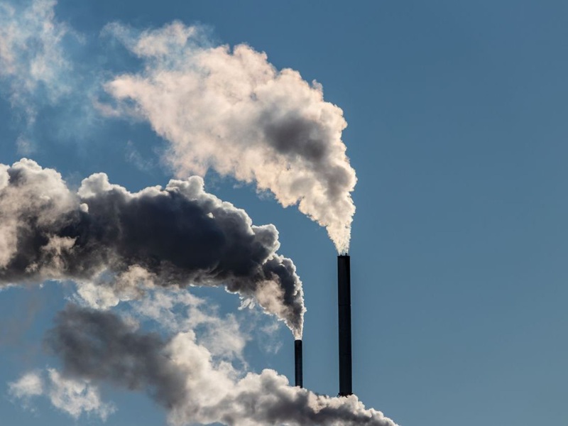 Factory stacks release emissions into the atmosphere
