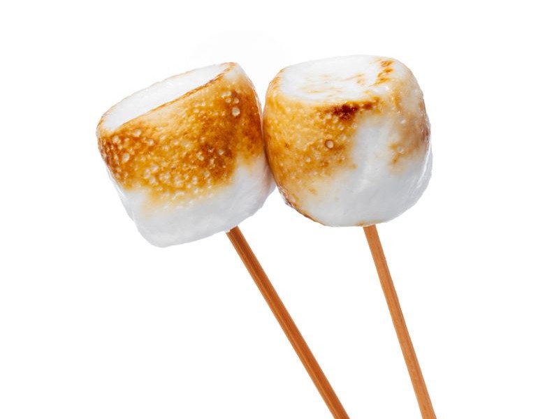 Marshmallows getting soft while roasting on sticks