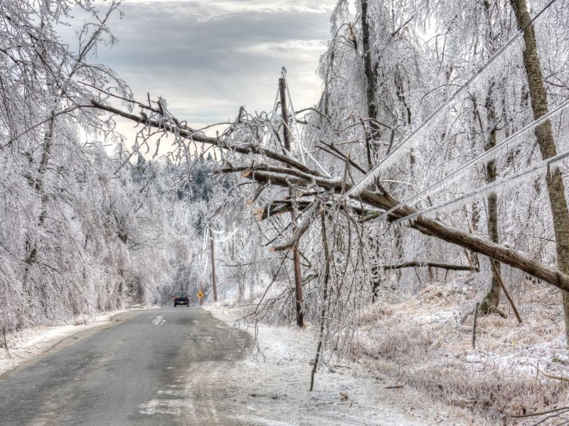 Dangerous road with power lines damaged after ice storm