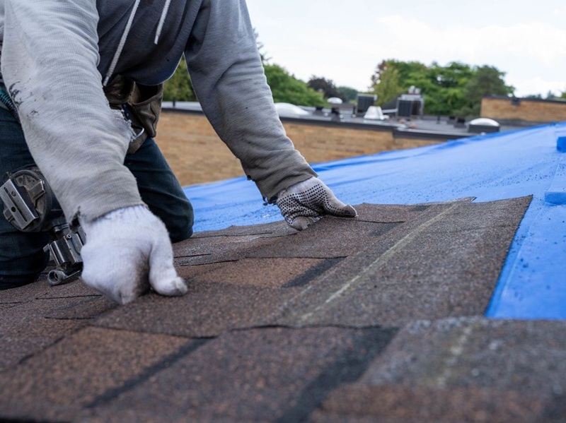Roofer installing a new roof on a house