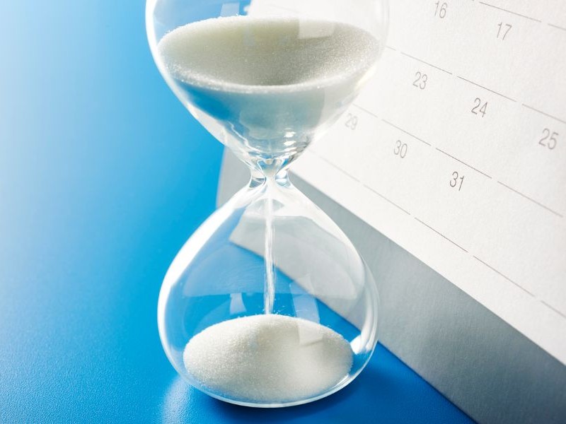 Hourglass and calendar representing change over time