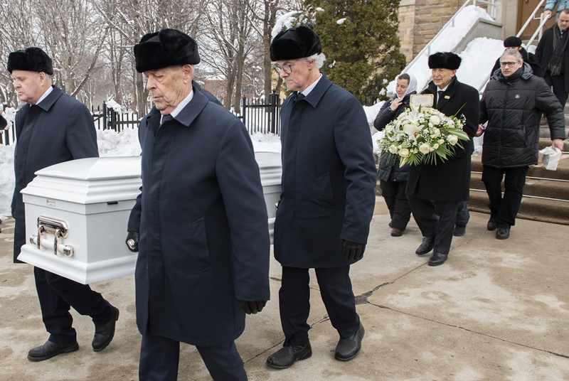 Pallbearers carry the casket of a 7-year-old who was killed by a hit-and-run driver