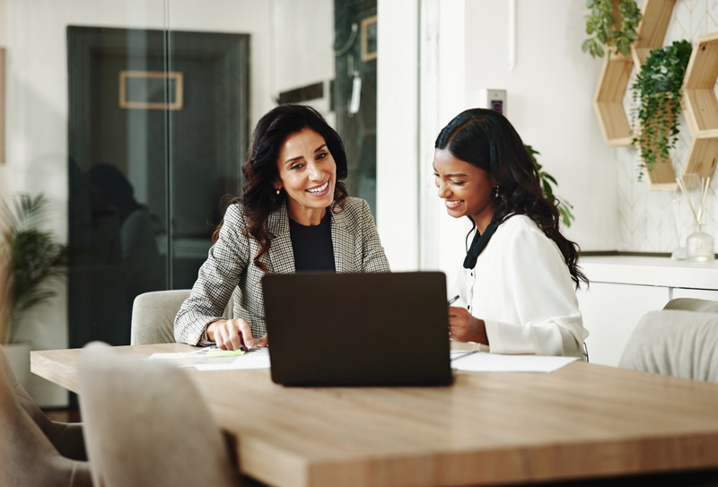 Meeting, women and business people with laptop in office, investment project and discussion. Teamwork, accountant and financial advisor with feedback for finance update, report review and documents