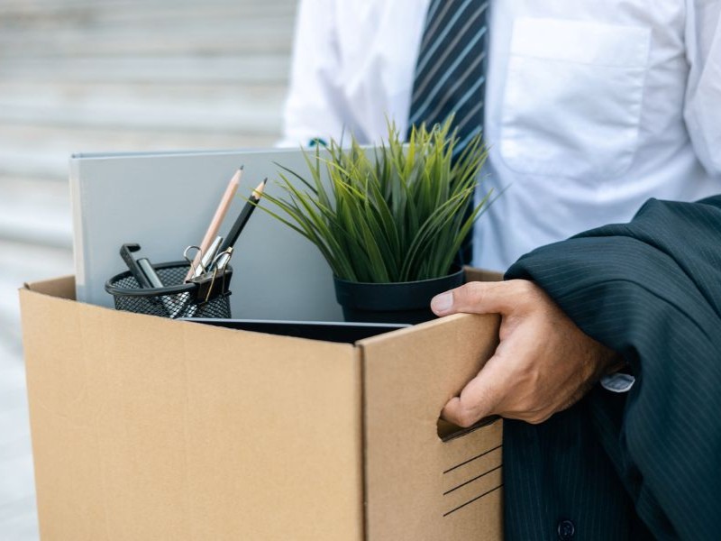 Employee carrying a box after cleaning out their desk