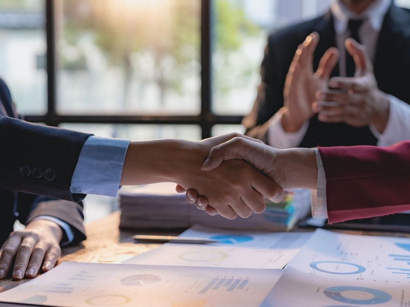 Business people shaking hands after deal