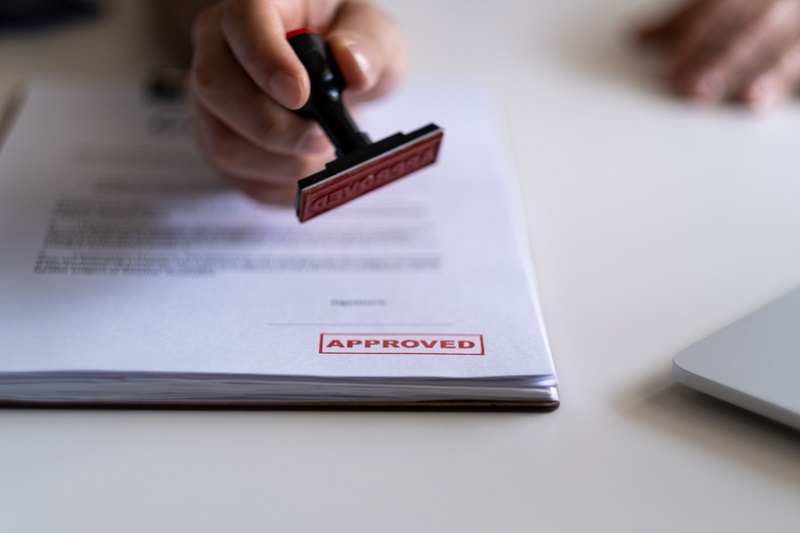 Business Man Stamping With Approved Stamp On Document.