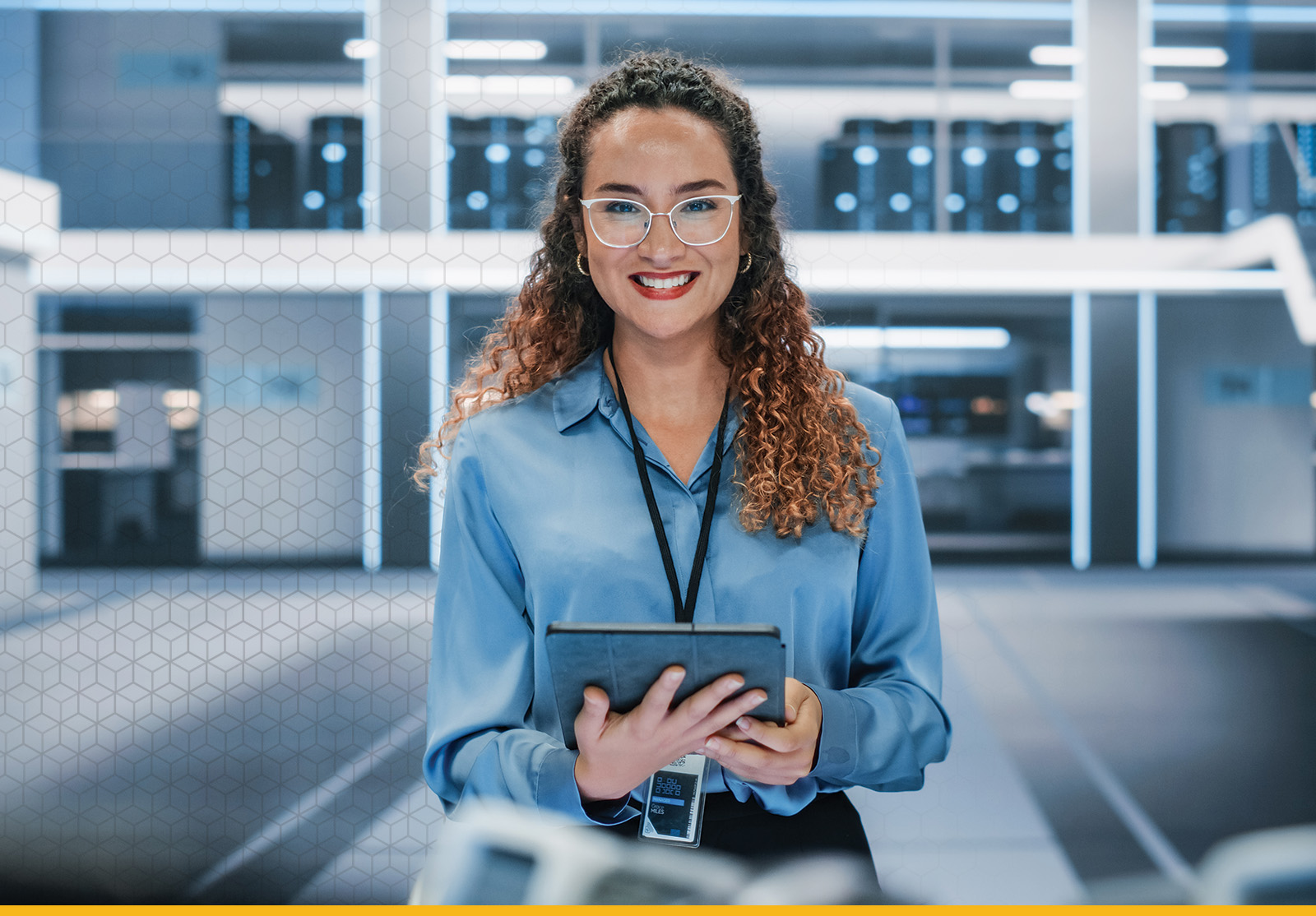 Woman in tech workspace holding tablet, surrounded by glowing servers and digital panels.