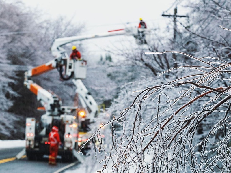 Linesmen work to restore power during an intense ice storm