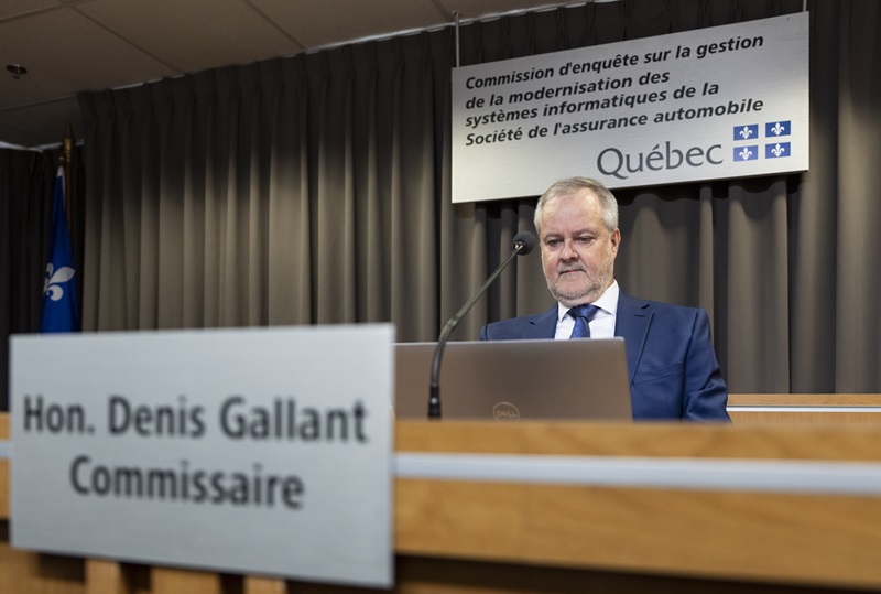 Commissioner Denis Gallant of the Commission d'enquête sur la gestion de la modernisation des systèmes informatiques de la Société de l'assurance automobile (SAAQ) waits to begin the public inquiry into the failure of Quebec's automobile insurance board's online portal, SAAQclic, in Montreal on Thursday, April 24, 2025. A public inquiry looking at costly digital shift by Quebec's automobile insurance board is hearing it could end up costing the province nearly half-a-billion dollars more than initially planned. THE CANADIAN PRESS/Christinne Muschi