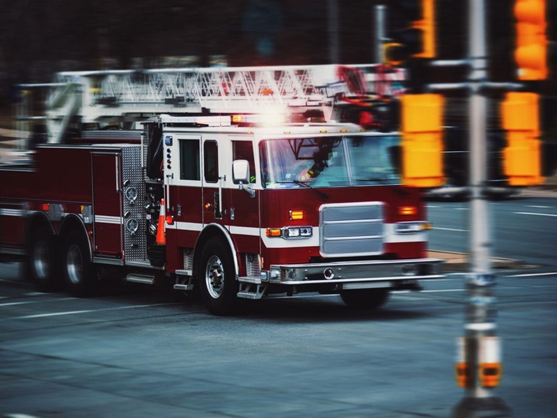 A fire truck speeding through an intersection