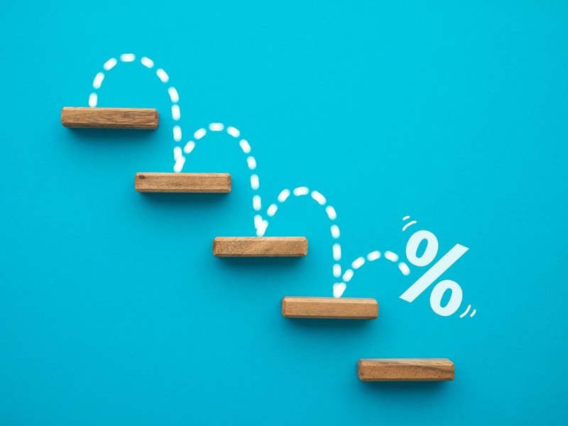 Percent sign moving down from top stair on blue background