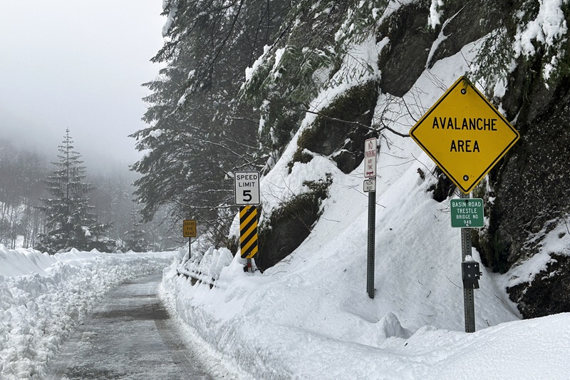 This photo taken Wednesday, Jan. 24, 2024, in Juneau, Alaska, shows a sign that warns people along Basin Road of avalanche risk. (AP Photo/Becky Bohrer)