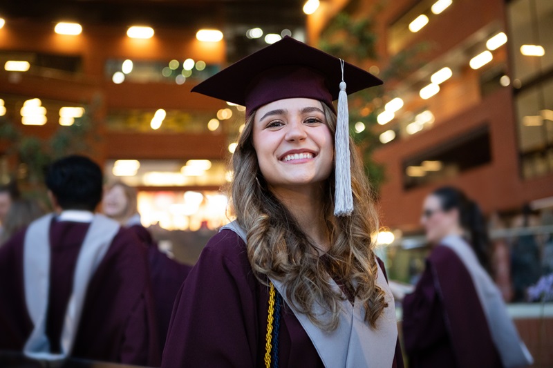 Portraits of young happy female graduates during graduation ceremony