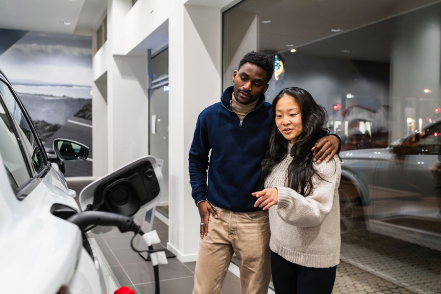 Couple discussing an electric vehicle purchase